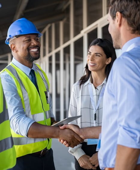 Construction worker shaking hands with a business owner